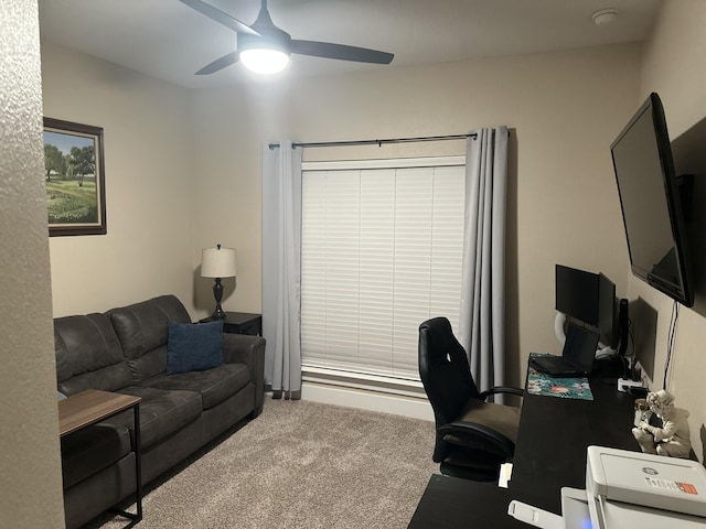 carpeted office space featuring ceiling fan