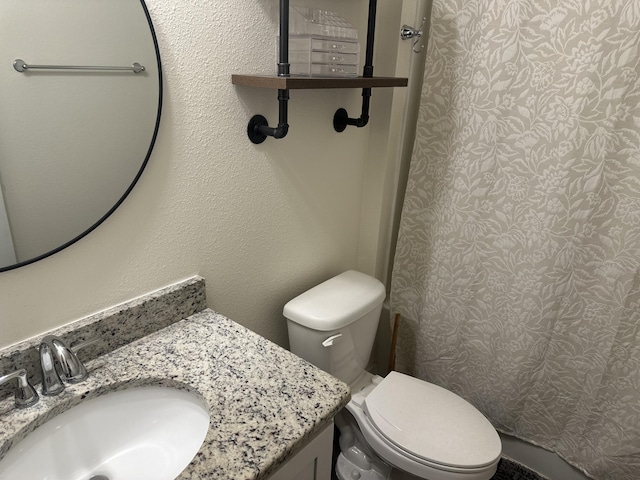 bathroom featuring vanity and toilet