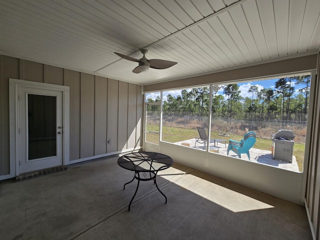 unfurnished sunroom with a ceiling fan