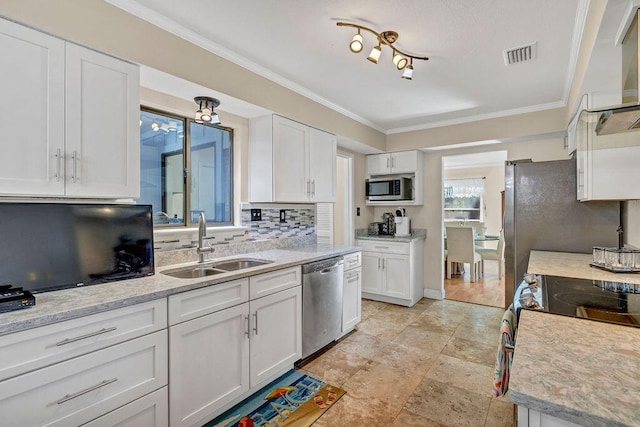 kitchen featuring tasteful backsplash, visible vents, appliances with stainless steel finishes, white cabinets, and a sink