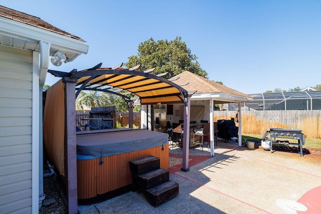 view of patio featuring a pergola, fence, and a hot tub