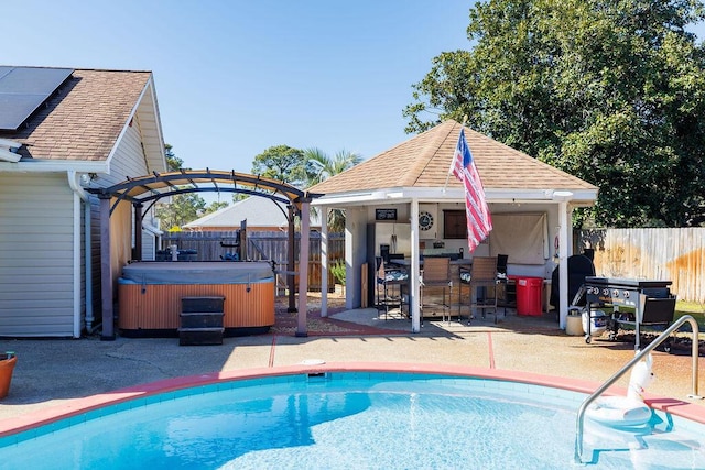 view of pool featuring a patio, a fenced backyard, outdoor dry bar, a fenced in pool, and a hot tub