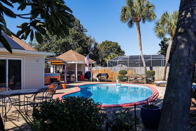 view of pool featuring a hot tub, fence, a fenced in pool, and a patio