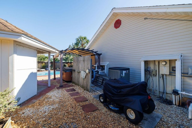 view of side of property with a fenced in pool, fence, and cooling unit