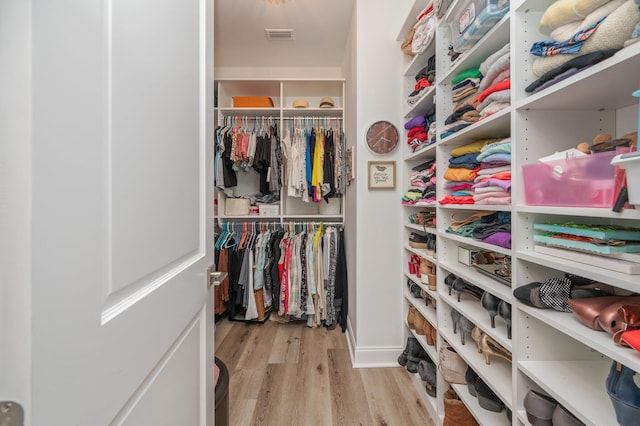 spacious closet with wood finished floors and visible vents