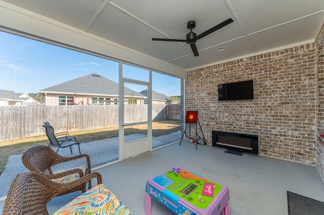 sunroom featuring a ceiling fan