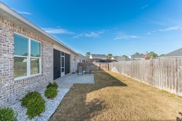 view of yard with a patio area and a fenced backyard