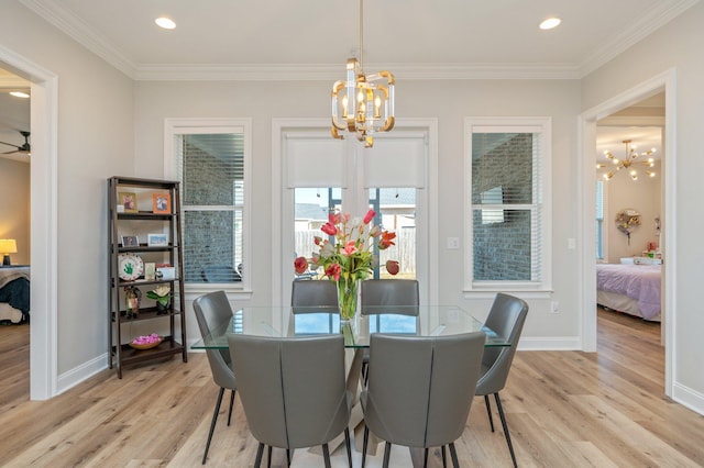 dining space featuring light wood-type flooring, baseboards, a chandelier, and ornamental molding