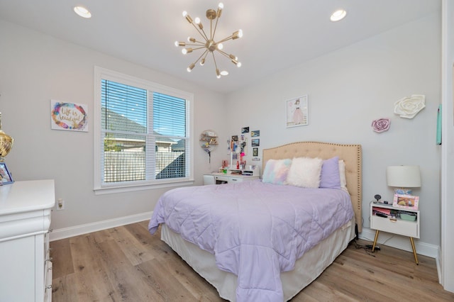 bedroom with a chandelier, recessed lighting, baseboards, and light wood finished floors