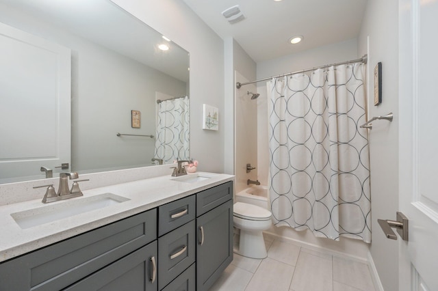 bathroom featuring toilet, tile patterned flooring, a sink, and shower / tub combo with curtain