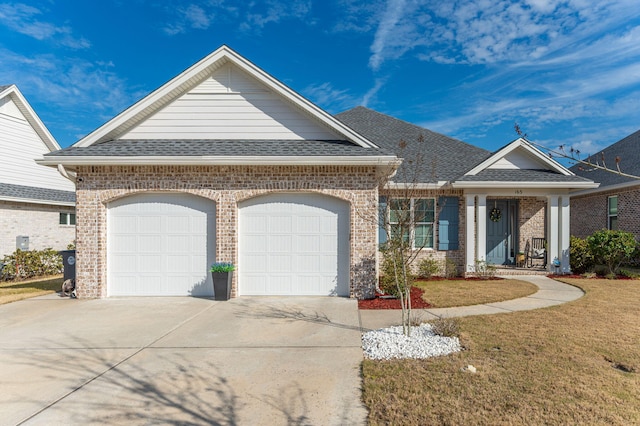 view of front facade with a garage, roof with shingles, driveway, and brick siding