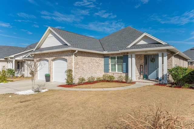 view of front of property with driveway, a garage, a shingled roof, a front lawn, and brick siding