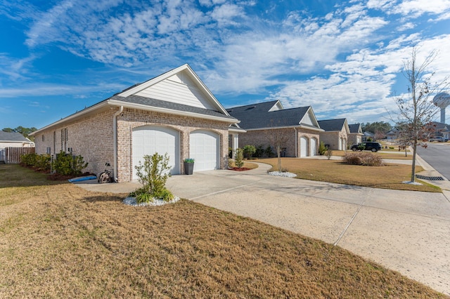 view of front facade featuring a garage, driveway, brick siding, and a front yard