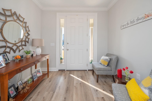 entrance foyer with ornamental molding, baseboards, and wood finished floors