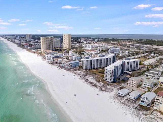 birds eye view of property featuring a water view, a view of city, and a beach view