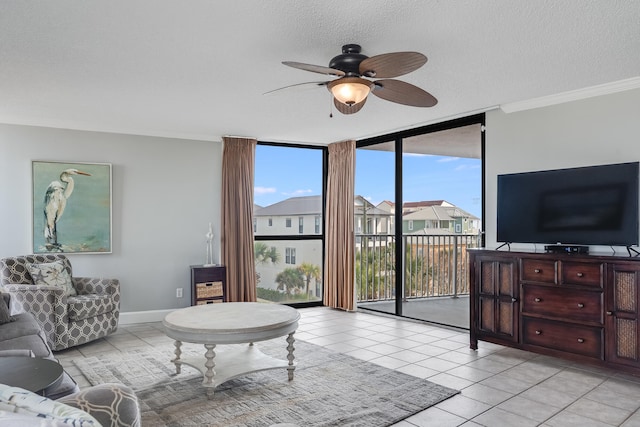 living area featuring floor to ceiling windows, ornamental molding, light tile patterned flooring, a textured ceiling, and baseboards