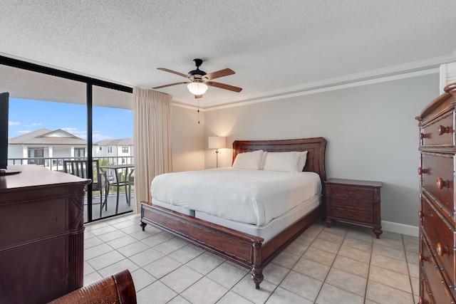 bedroom with access to outside, floor to ceiling windows, a textured ceiling, and light tile patterned floors