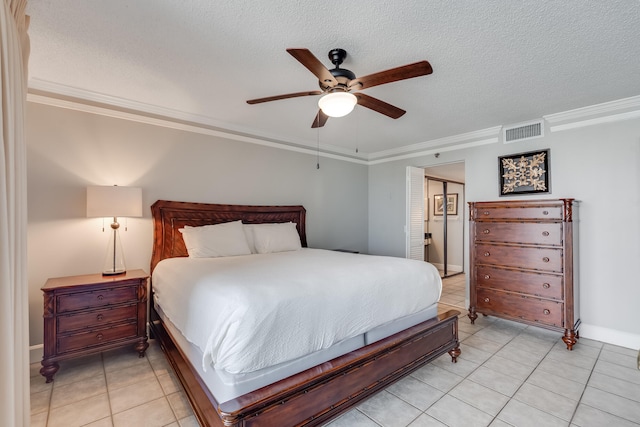 bedroom featuring a textured ceiling, ornamental molding, light tile patterned floors, and visible vents