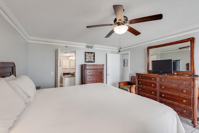 bedroom with a textured ceiling, ensuite bathroom, a ceiling fan, visible vents, and crown molding