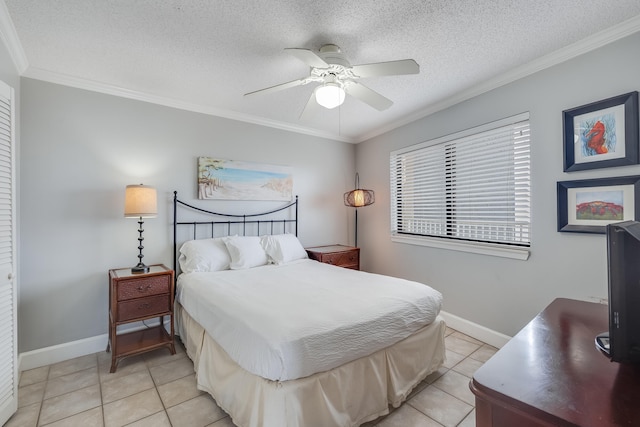 bedroom with ornamental molding, light tile patterned flooring, a textured ceiling, and baseboards