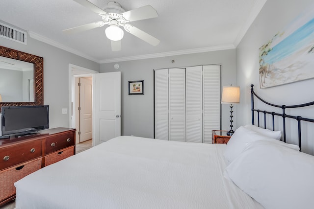 bedroom featuring a ceiling fan, visible vents, a closet, and ornamental molding