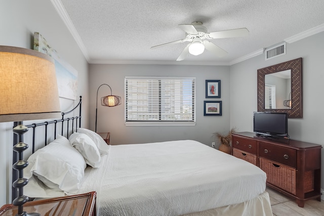 bedroom with visible vents, crown molding, and a textured ceiling