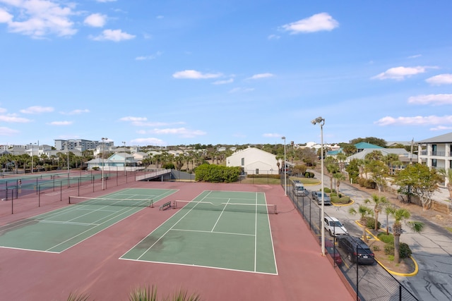 view of sport court featuring a residential view and fence