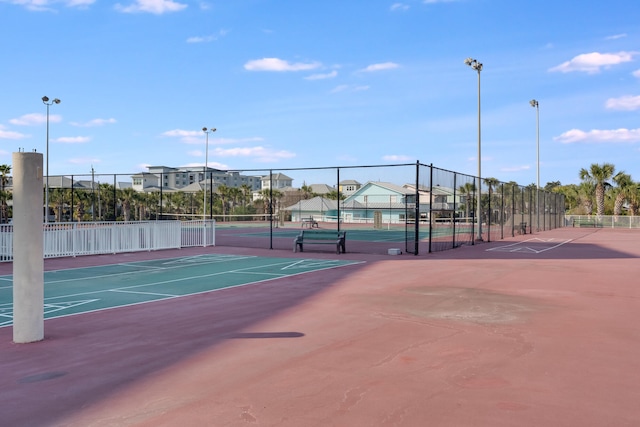 view of tennis court featuring fence