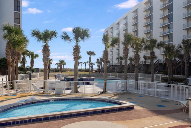 community pool featuring a patio area and fence