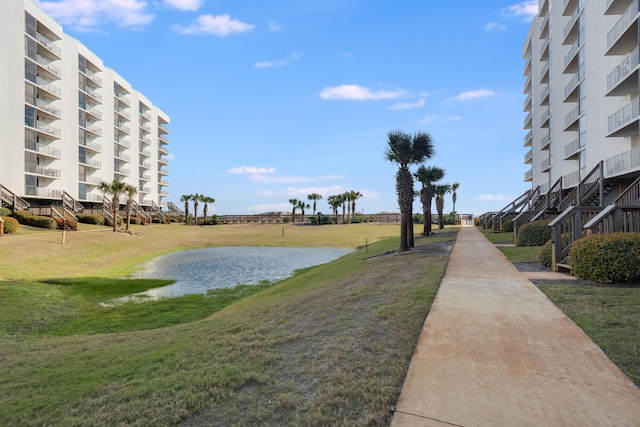 view of home's community with a yard and a water view