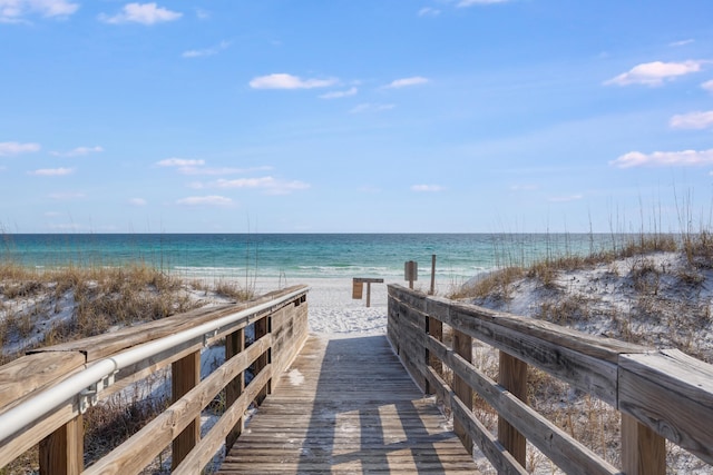 exterior space featuring a water view and a beach view