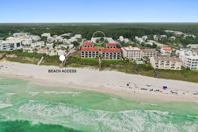 drone / aerial view featuring a water view and a beach view