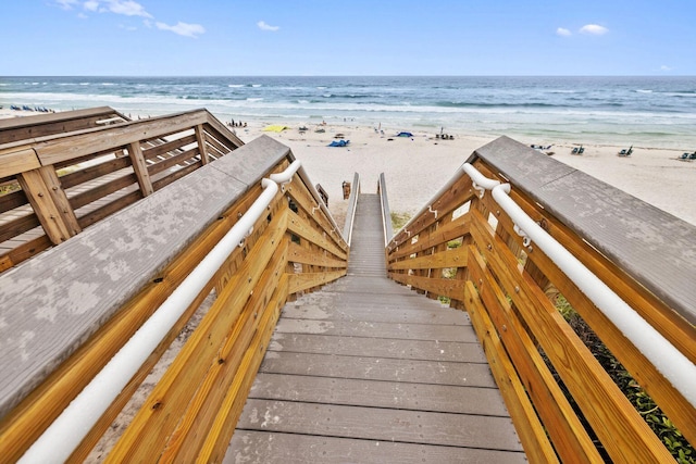 surrounding community with a water view and a view of the beach