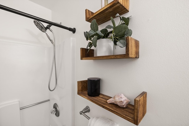 interior details featuring tub / shower combination