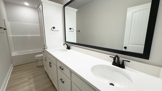 2720 Louis Cir, Crestview, FL 32536 - bathroom with toilet, double vanity, a sink, and wood finished floors