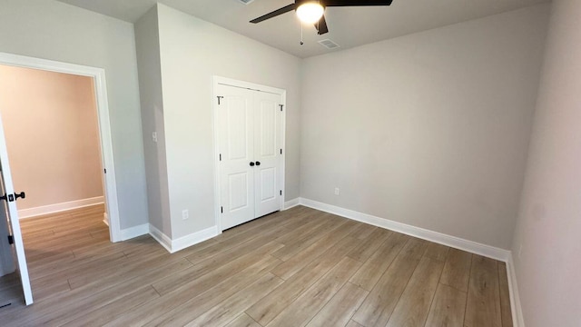 2720 Louis Cir, Crestview, FL 32536 - unfurnished bedroom with light wood finished floors, baseboards, a closet, and visible vents