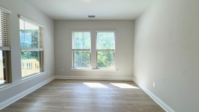 2720 Louis Cir, Crestview, FL 32536 - unfurnished room with baseboards, a wealth of natural light, light wood-style floors, and visible vents