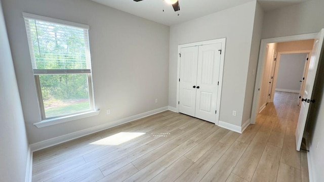 2720 Louis Cir, Crestview, FL 32536 - unfurnished bedroom with a closet, baseboards, a ceiling fan, and light wood-style floors