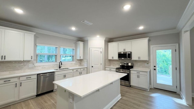 2720 Louis Cir, Crestview, FL 32536 - kitchen featuring stainless steel appliances, tasteful backsplash, ornamental molding, and a sink