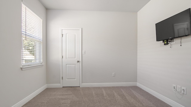 spare room with carpet flooring and baseboards
