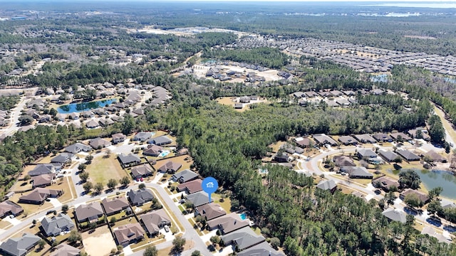 birds eye view of property with a residential view and a wooded view