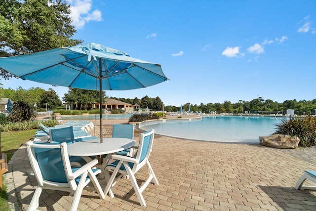 232 Brighton Cv, Freeport, FL 32439 - community pool with a patio area and outdoor dining space