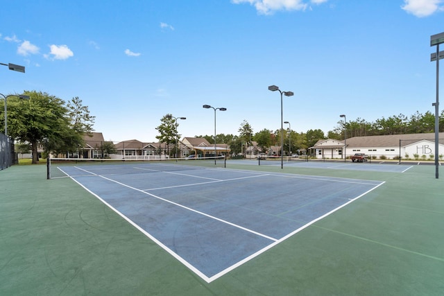 232 Brighton Cv, Freeport, FL 32439 - view of tennis court with fence, a residential view, and community basketball court