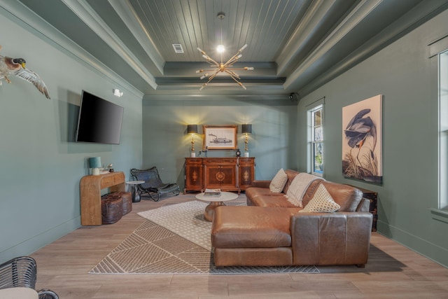 232 Brighton Cv, Freeport, FL 32439 - living area featuring a tray ceiling, crown molding, wood finished floors, baseboards, and a chandelier