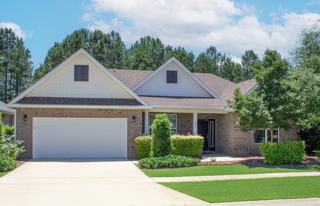 232 Brighton Cv, Freeport, FL 32439 - view of front of property with brick siding, an attached garage, concrete driveway, and roof with shingles