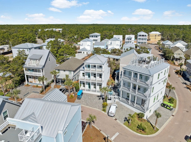 drone / aerial view featuring a forest view and a residential view