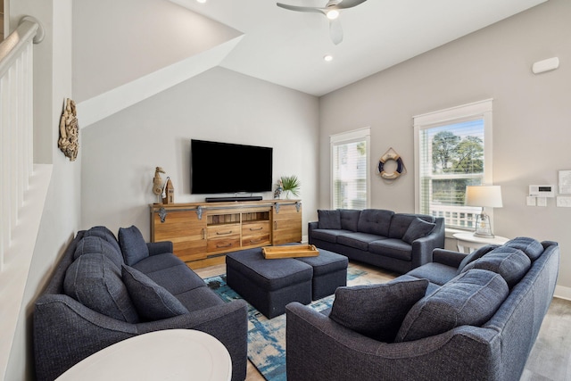 living area with a ceiling fan, baseboards, lofted ceiling, recessed lighting, and light wood-style floors