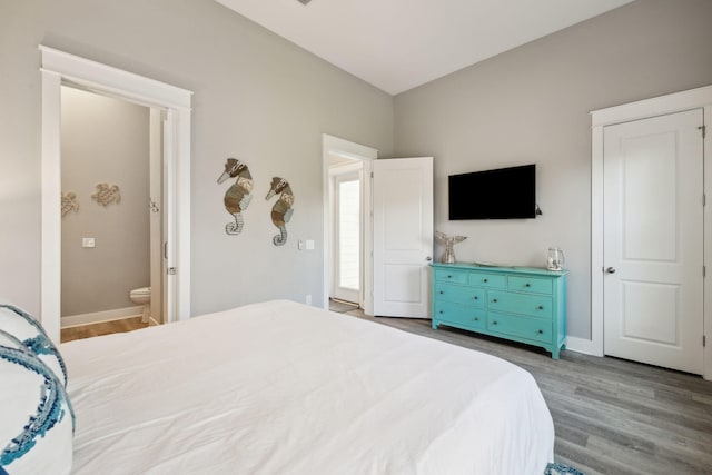 bedroom with baseboards and wood finished floors