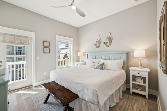 bedroom featuring a ceiling fan, access to outside, wood finished floors, and baseboards