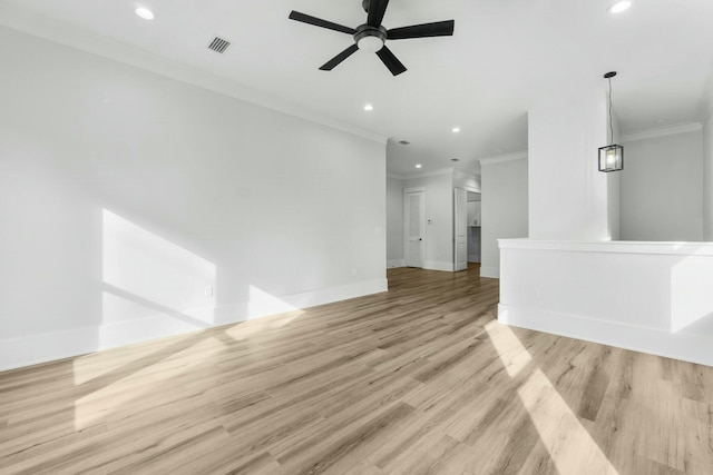 spare room with ornamental molding, light wood-style flooring, visible vents, and recessed lighting